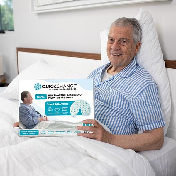 Man in bed holding a product packaging with 'Quick Change' branding.