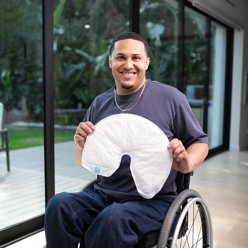 Man in a wheelchair with a QuickChange Wrap overlay