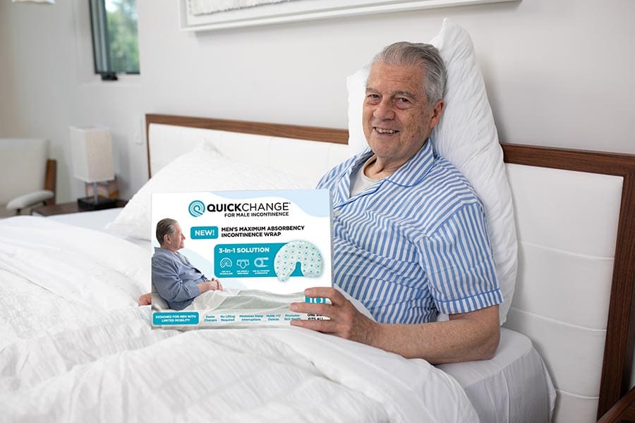 Man in bed holding a product packaging with 'Quick Change' branding.